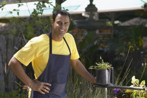 Professional gardener trimming plants in a Clerkenwell outdoor space